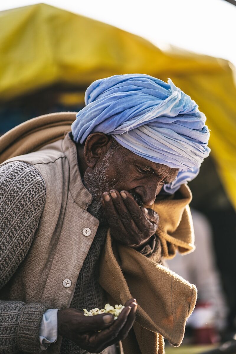 a man with a blue turban eating food
